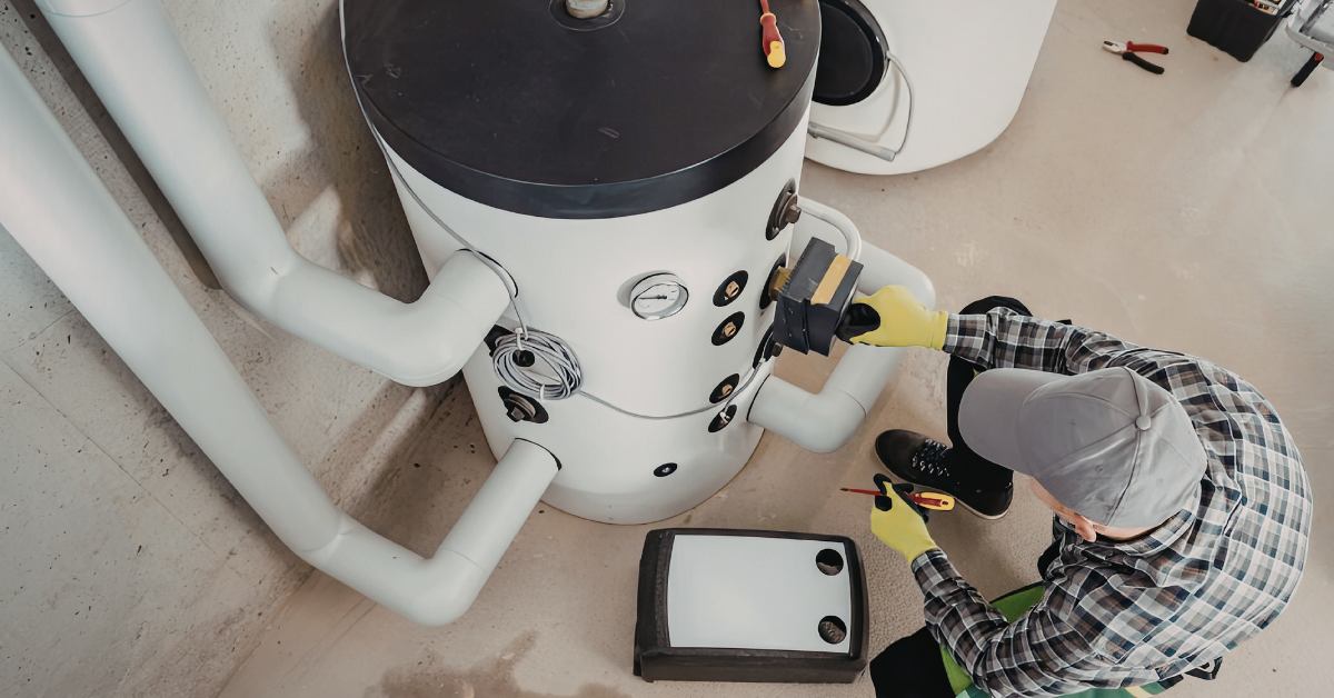 Plumber inspecting sink pipes during spring plumbing maintenance in Champaign IL